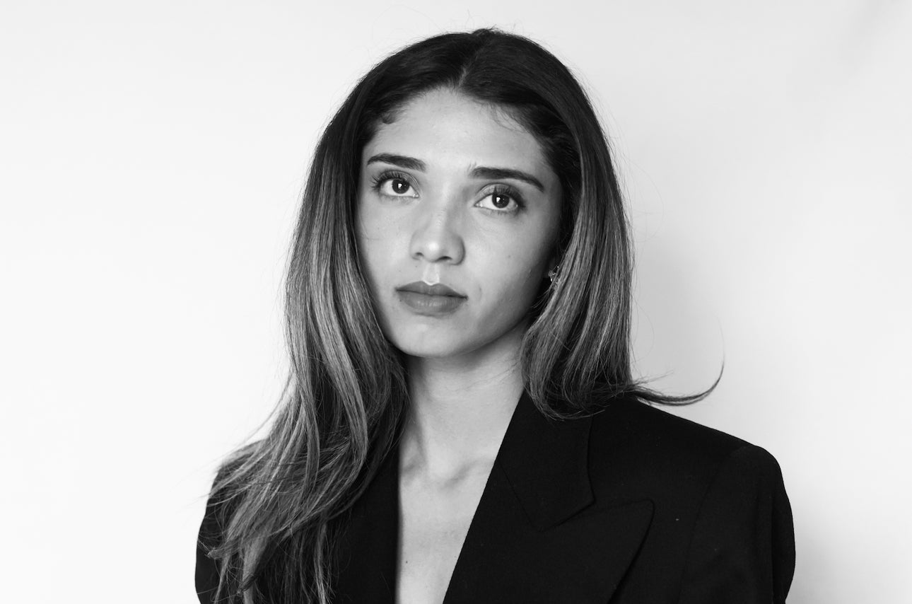 Stephanie Navarette - Black and white portrait of a woman with long hair against a plain background